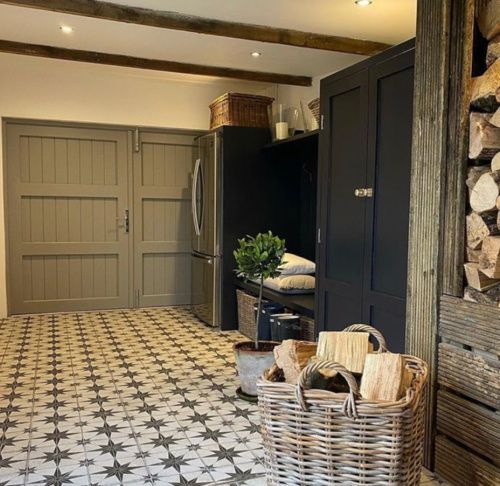 a kitchen with black and white tile flooring