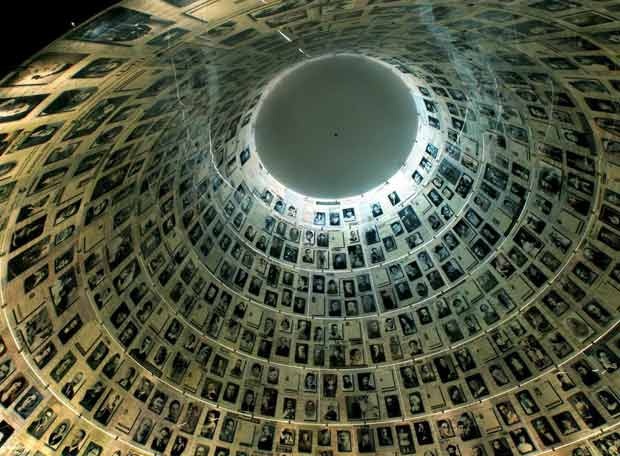 the inside of a building with many pictures on it's sides and a round hole in the middle