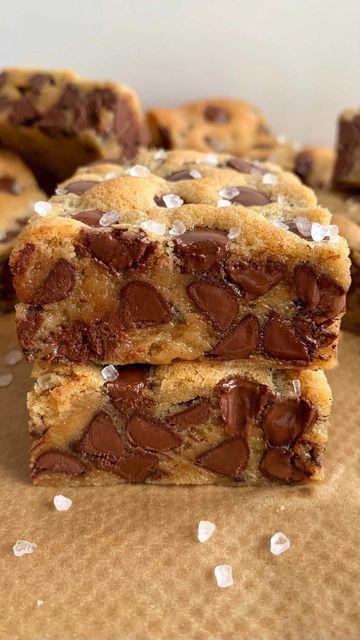 two chocolate chip cookies stacked on top of each other with white sprinkles