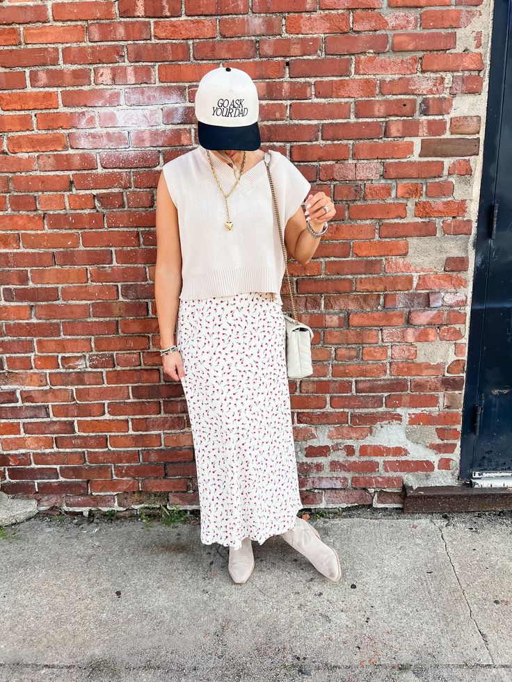 Put some flower power into your wardrobe with our Tammy Floral Midi Skirt! This ivory skirt features a red micro floral print and a comfortable elastic waistband. Perfect to pair with both graphic tees and sweaters, this midi skirt will add a playful touch to any outfit. Product Details: Measurements: WAIST small 13" medium 14" large 14.5" LENGTH small 34" medium 35" large 36" 100% polyester midi length elastic waist fully lined super comfortable model wearing size small model stats: size 4, 5'5 Casual Red Maxi Skirt For Fall, Casual White Skirt For Fall, Spring Daywear Maxi Skirt, White Maxi Skirt For Fall, Casual Maxi Skirt For Fall Daywear, Casual Fall Maxi Skirt For Daywear, Casual Red Maxi Skirt For Spring, Casual Maxi Skirt For Spring Daywear, Casual Midi-length Skirt With Floral Print