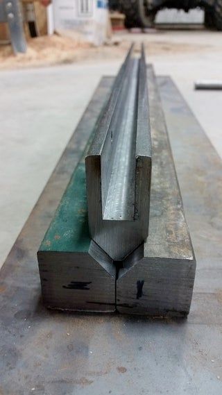 a piece of metal sitting on top of a conveyor belt