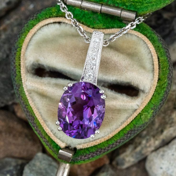 This pretty amethyst slide pendant necklace features a centered oval cut amethyst. Set into the sides of the basket are two bezel set tourmaline accents and it is finished with a diamond bail. The pendant necklace is crafted in 14k white gold and measures 18 inches long. Amethyst Set, Ruby Jewelry, Amethyst Jewelry, Yellow Gold Pendants, Amethyst Pendant, Rings Jewelry, February Birth Stone, Diamond Pendant Necklace, June Birth Stone