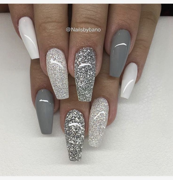 a manicure with silver and white glitters on the tip of each nail is shown