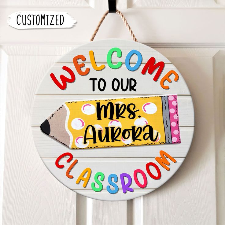 a welcome sign hanging on a door with a crayon pencil in the center