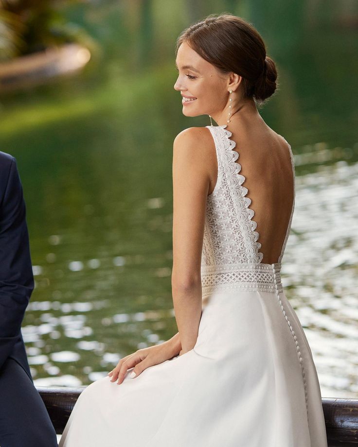 a woman in a white dress sitting next to a man