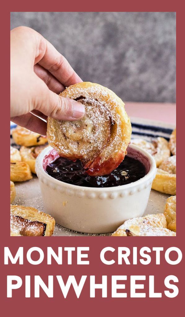 a person dipping blueberry filling into a pastry in a small bowl with the words monte cristo pinwheels on it