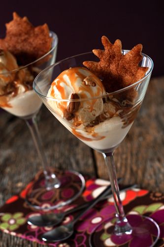 two glasses filled with dessert sitting on top of a table