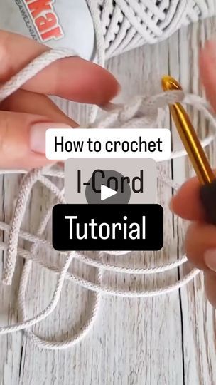 someone is crocheting with yarn on a white wooden surface and the text reads how to crochet i cord