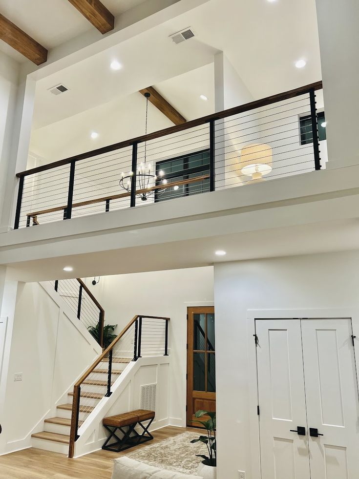 an open floor plan with stairs and white walls