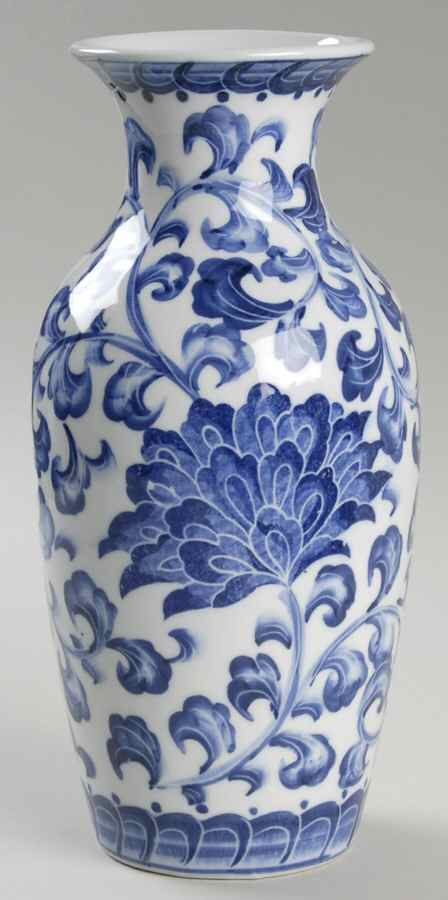 a blue and white vase sitting on top of a table