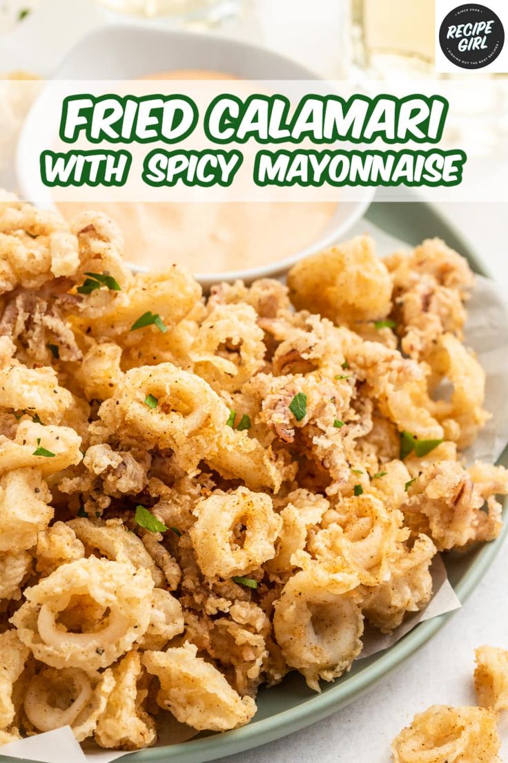 fried calamari with spicy mayonnaise served on a white and green plate