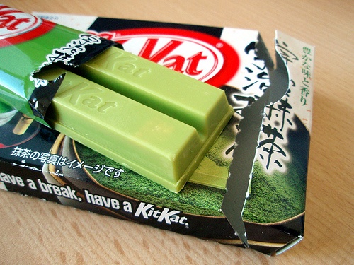 two packaged candy bars sitting on top of a wooden table