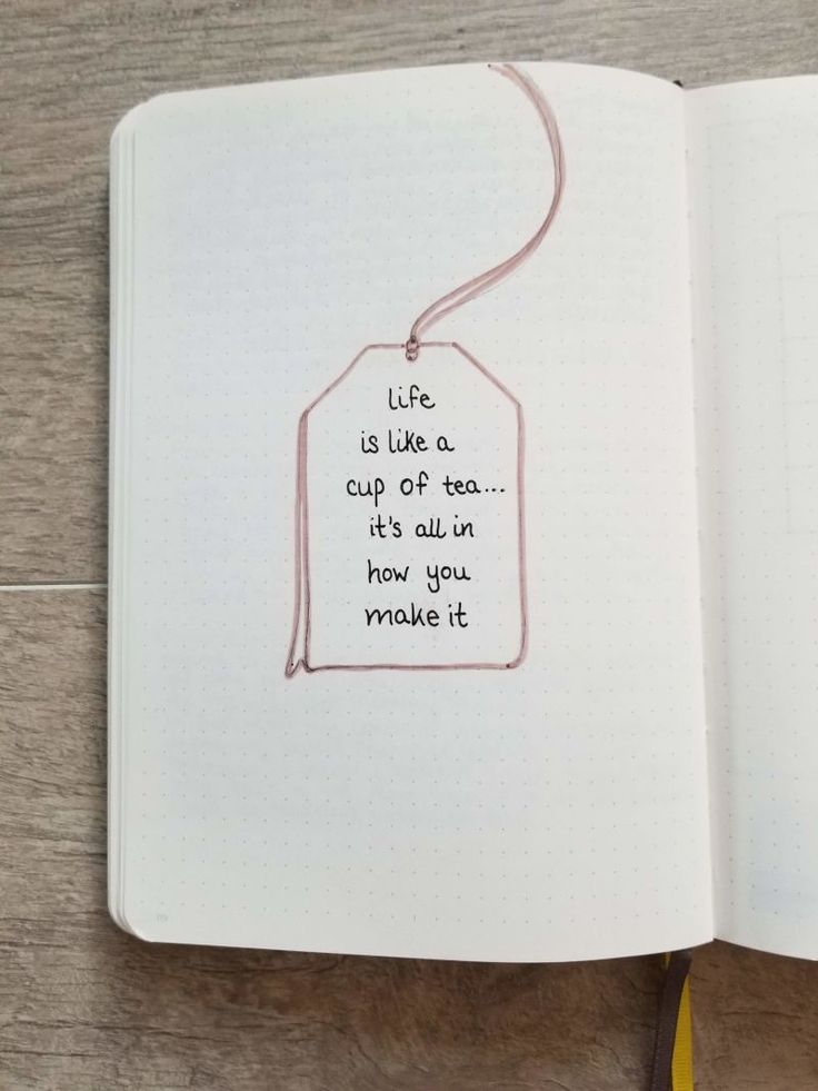 an open notebook with writing on it and a tag attached to the cover that says life is like a cup of tea, it's all in how you make it