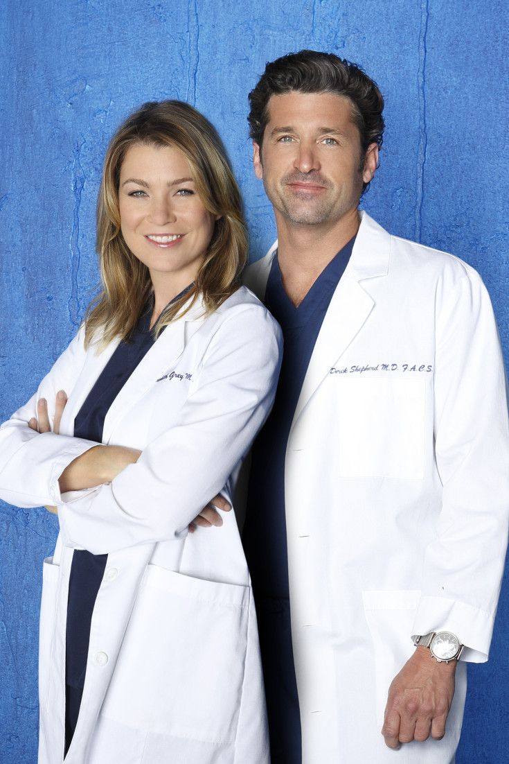 a man and woman standing next to each other in front of a blue wall with the words grey's anatomy on it