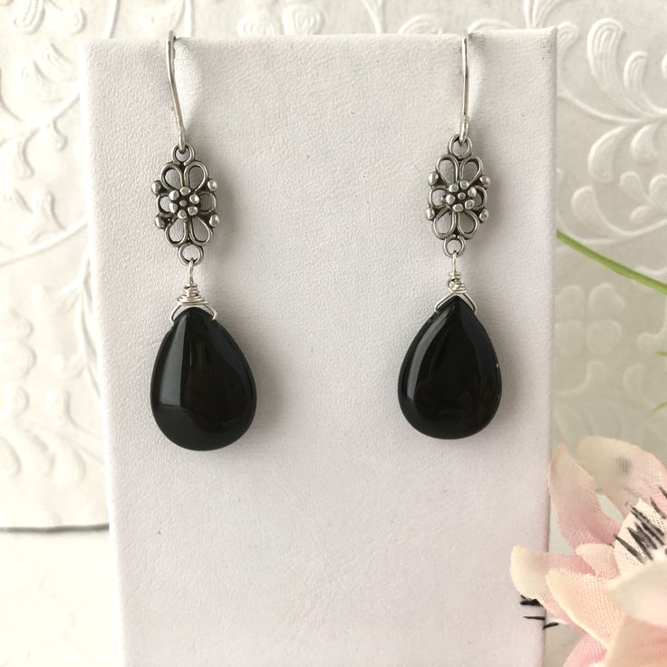 Timeless earrings made of solid black agate and antiqued sterling silver filigree components. Elegant Onyx Earrings, Elegant Onyx Dangle Earrings, Elegant Pierced Teardrop Earrings With Adjustable Fit, Elegant Teardrop Onyx Jewelry, Elegant Adjustable Nickel-free Teardrop Earrings, Elegant Onyx Drop Jewelry, Elegant Black Long Drop Jewelry, Black Drop Jewelry With Pierced Details, Black Drop-shaped Pierced Jewelry