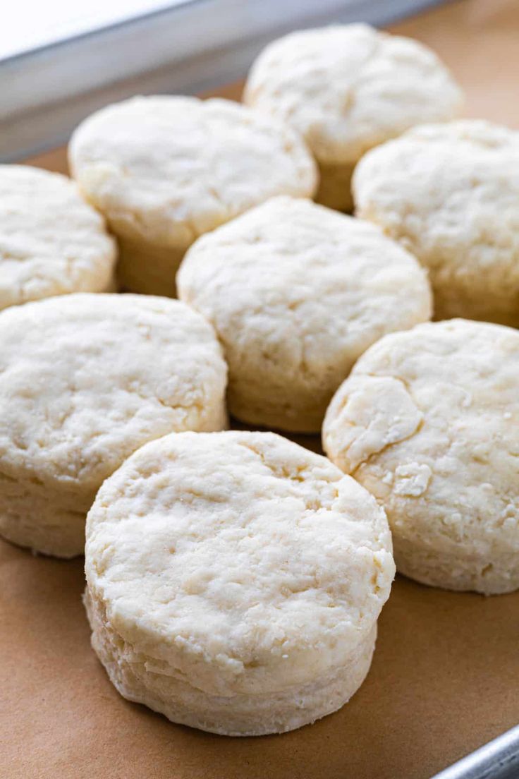 a bunch of biscuits sitting on top of a cookie sheet