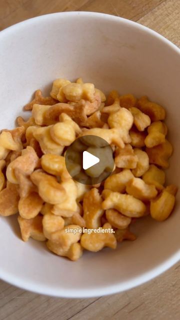 a white bowl filled with macaroni and cheese on top of a wooden table