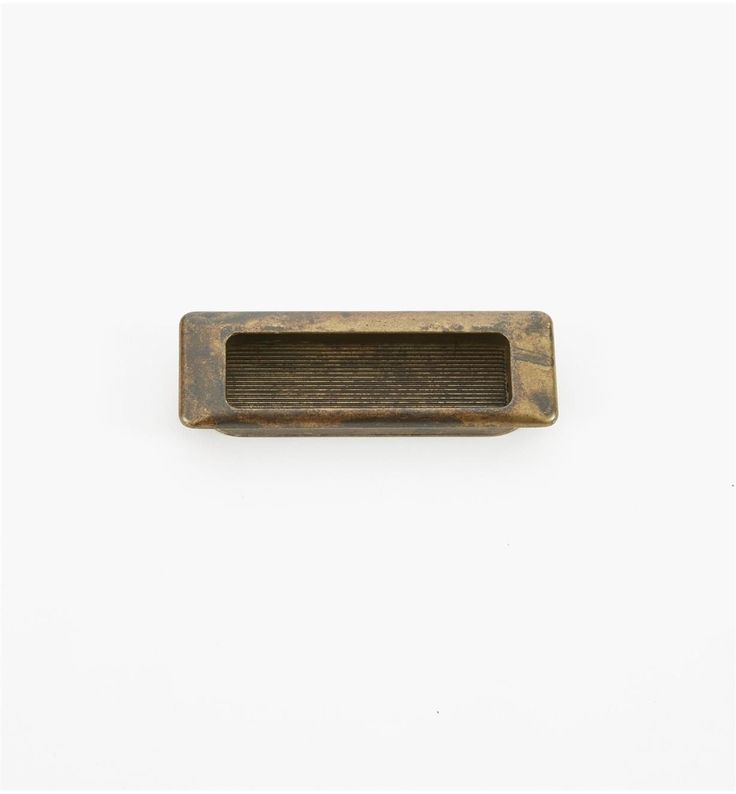 an old brass drawer handle on a white background