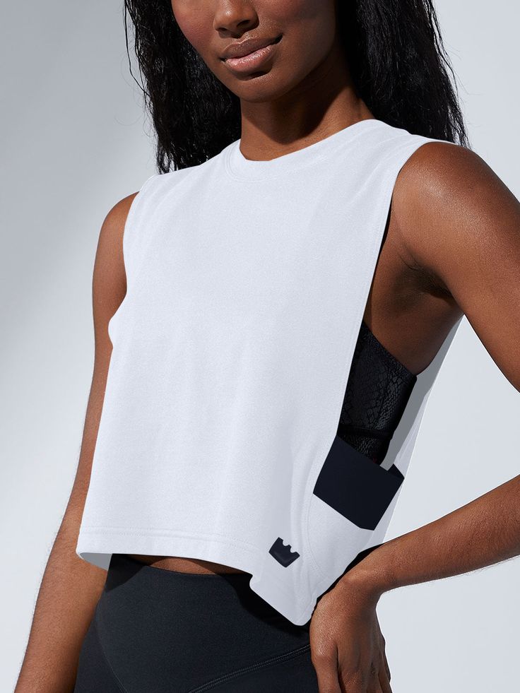 Part of our new tank collection! Get the ultimate freedom of arm movement in our modern muscle tank. Just pop it on for a quick shot of coverage, comfort and confidence. It’s flexible, too! Can be worn to work out or as a layering piece for your wardrobe. Shipped in an environmentally sustainable poly mailer.Turn inside out to wash.Hand wash or wash inside laundry bag in cold water only.If machine washing use cold water, delicate cycle. Do not use fabric softeners. Do not bleach.Lay flat to dry. Lounge Bra, New Tank, High Impact Sports Bra, Poly Mailer, Longline Bra, Pop It, Black Sports Bra, Workout Tanks, Muscle Tank