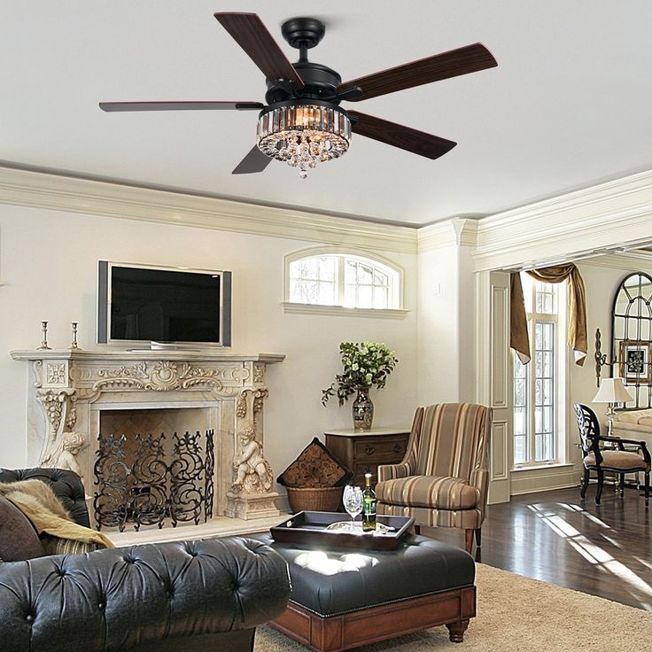 a living room filled with furniture and a flat screen tv mounted on the wall next to a fire place