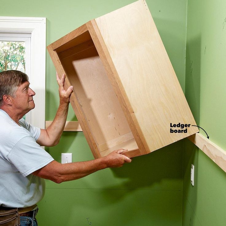 a man holding a wooden box with the lid open