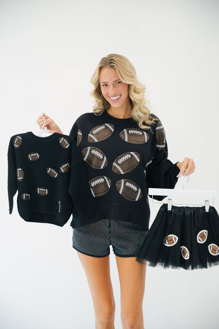 This MINI KIDS FOOTBALL LOVER SWEATER is perfect for young football fans. It is made of a black sweater that features unique football patches, making it ideal for game days, practice days, or any day! Its comfy construction and stylish patches make it a must-have for any mini fan. All orders are currently shipping within 14 business days. To receive item quicker, expedited shipping is available at checkout. Saints Game, Black Tutu, Football Lover, School Collection, Cropped Pullover, Football Kids, Football Lovers, Mini Fan, Black Pullover