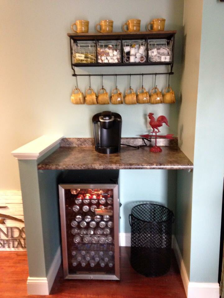 an image of a small bar in the corner of a room with jars and cups on it