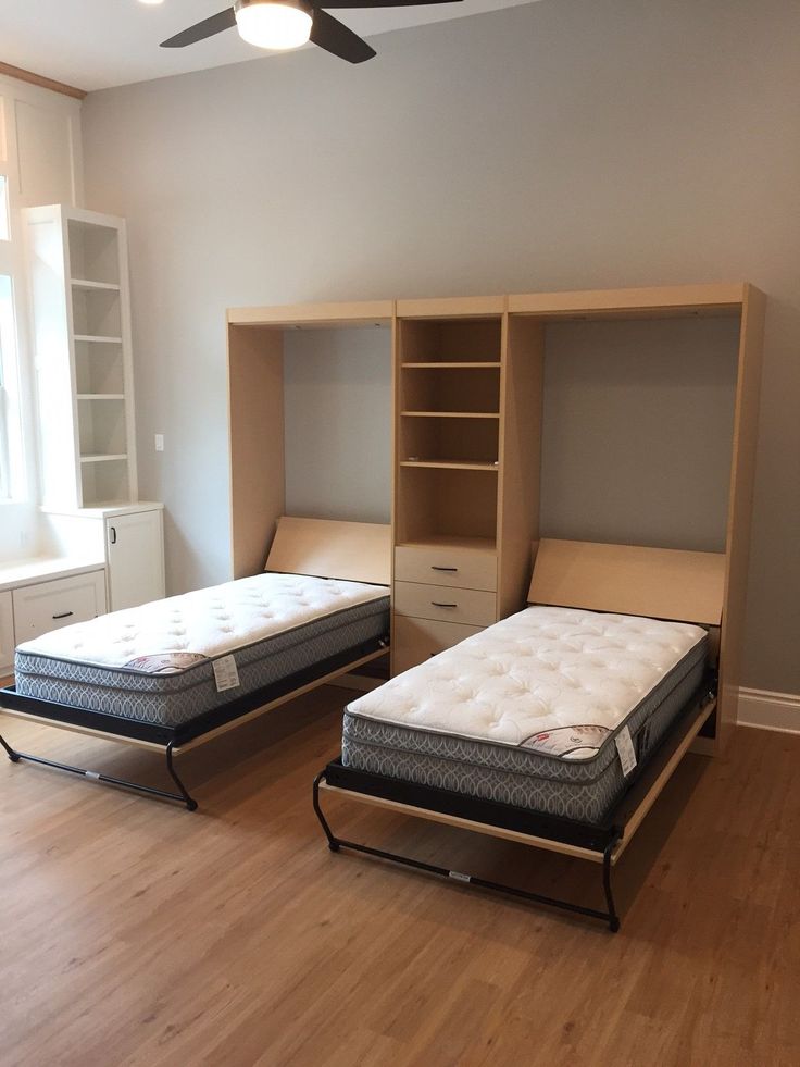 two mattresses are sitting in an empty room