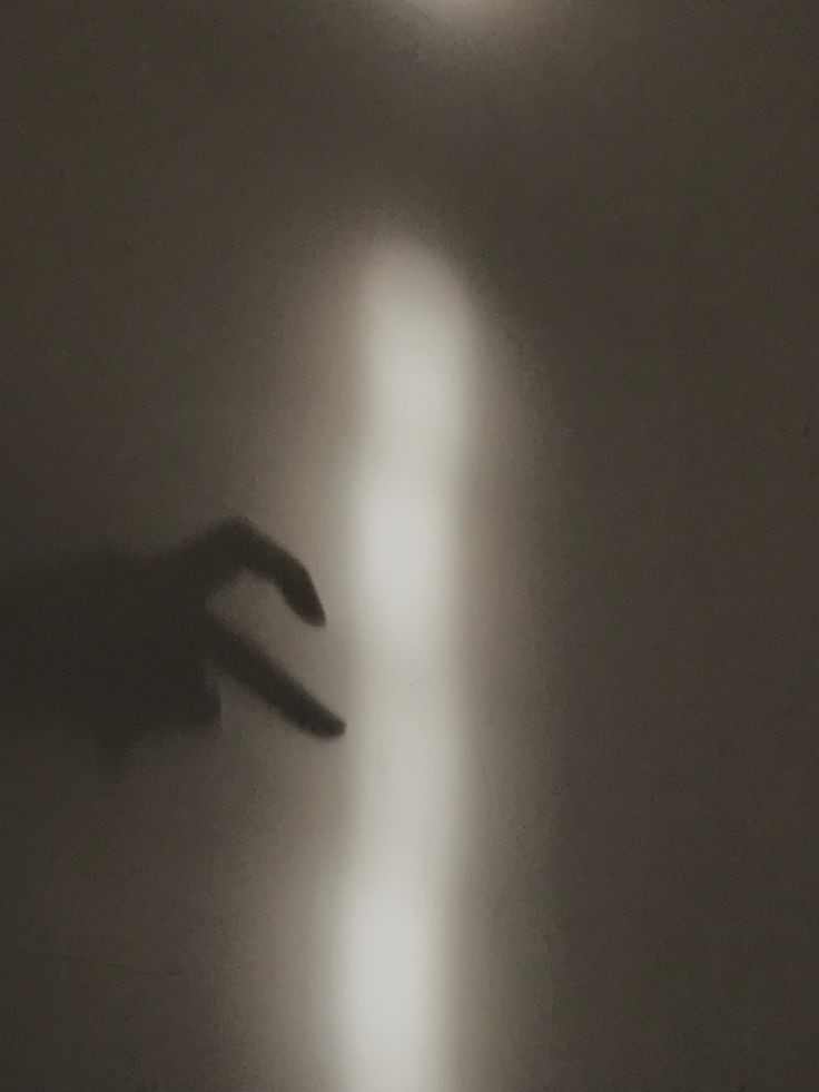 a blurry image of a person's hand reaching for something