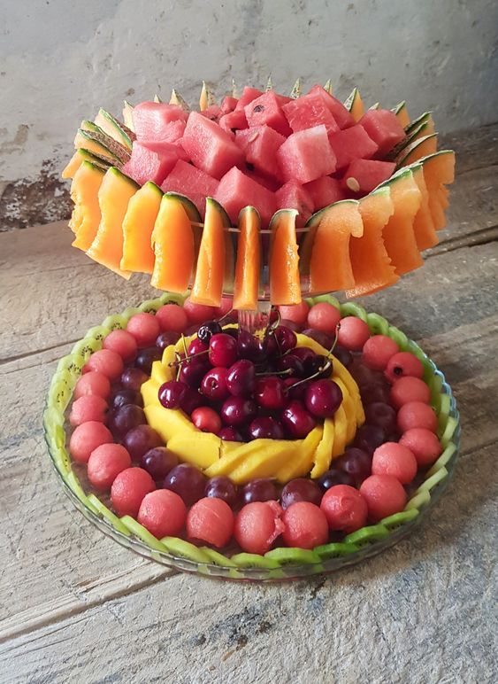 a fruit platter with watermelon, grapes, melon, and bananas