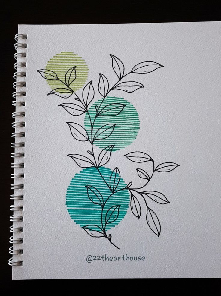 a spiral notebook with leaves and circles on it