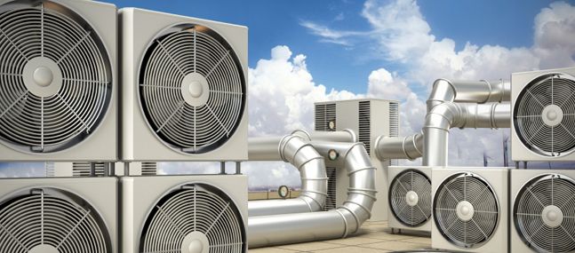 three air conditioners sitting next to each other on top of a tiled floor with sky in the background