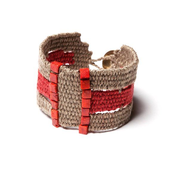 a woven bracelet with red and beige strips