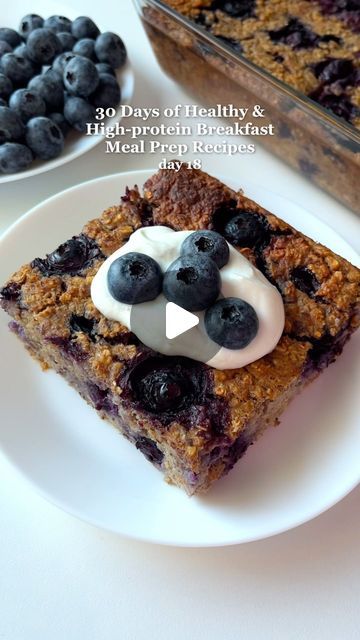 a piece of cake on a plate with blueberries and yogurt in the middle