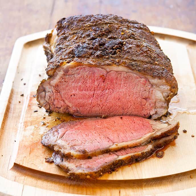 a piece of roast beef on a cutting board