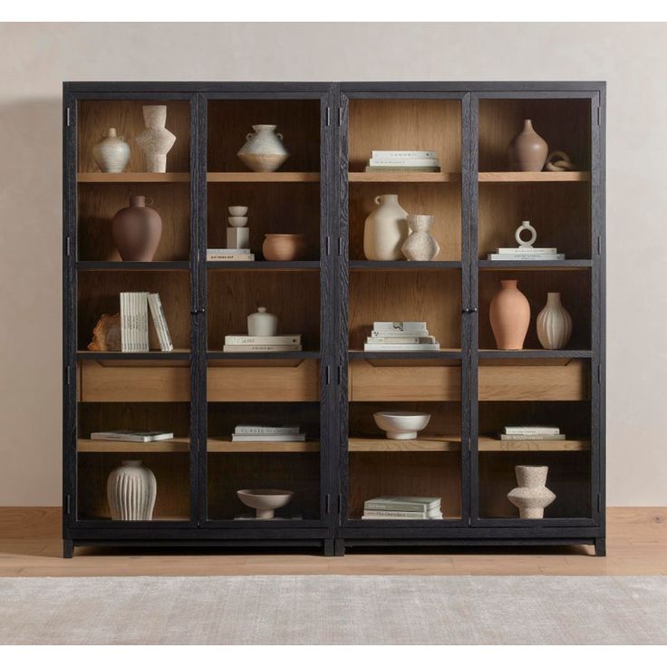 an open bookcase with many vases on it