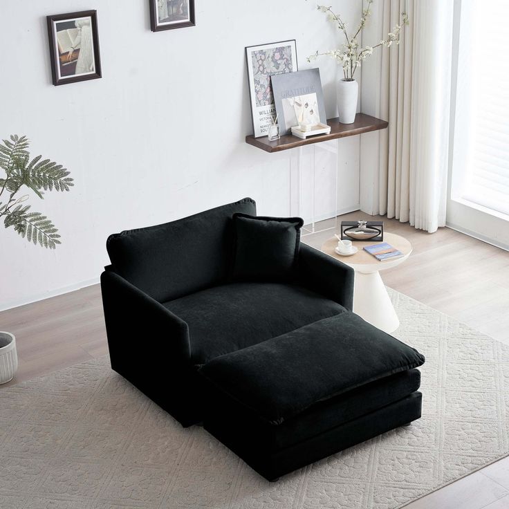 a black chair sitting on top of a white rug