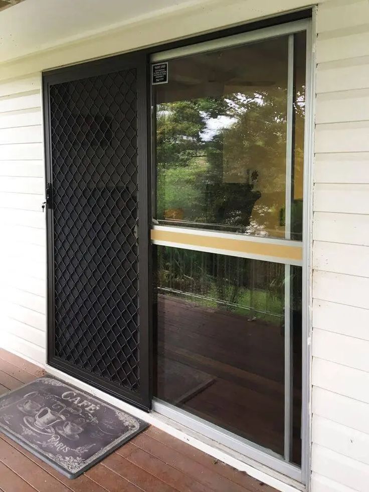 the front door is open to let in some light and privacy from the sun porch