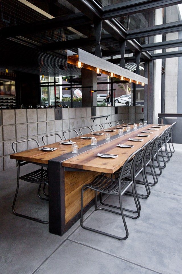 a long wooden table with chairs around it