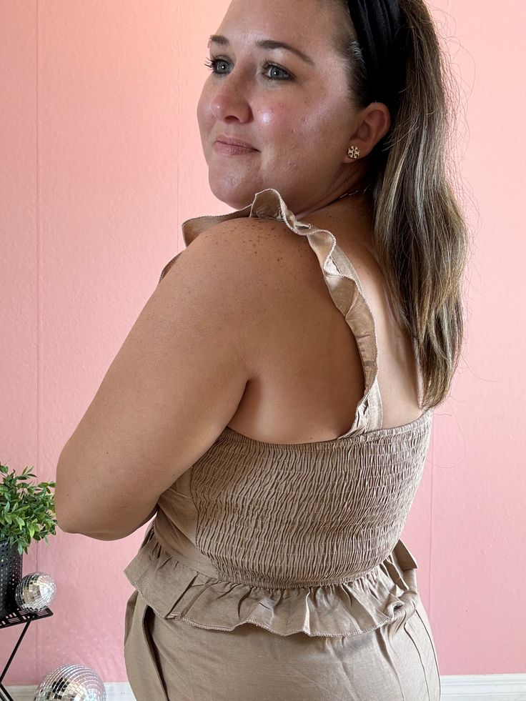 Product Description: Introducing our Olivia Linen Ruffled Top in a beautiful toasted almond color. Featuring the most darling ruffles and a cropped fit, this top goes beautifully with it's matching shorts or with your favorite bottoms including denim, trousers, shorts and skirts! A must have for summer, our Piper Linen Ruffled Top takes a beautiful basic tank up a level and will easily be dressed up and down all season long. Want to turn it into a set? Check out our Piper Linen Shorts Quick Prod Chic Cropped Ruffle Crop Top, Cropped Ruffle Hem Top For Day Out, Chic Ruffled Crop Top For Spring, Chic Ruffled Crop Top For Brunch, Chic Cotton Crop Top With Ruffles, Feminine Beige Crop Top For Spring, Feminine Ruffled Crop Top For Day Out, Feminine Ruffled Crop Top For Brunch, Feminine Beige Crop Top For Summer