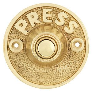 brass plated press button with the word press on it's center and bottom