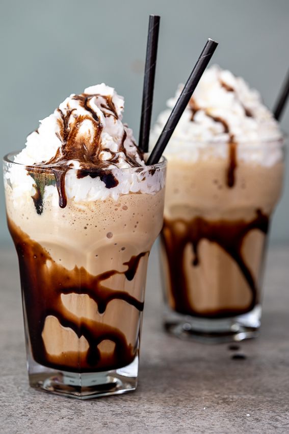 two glasses filled with ice cream and chocolate