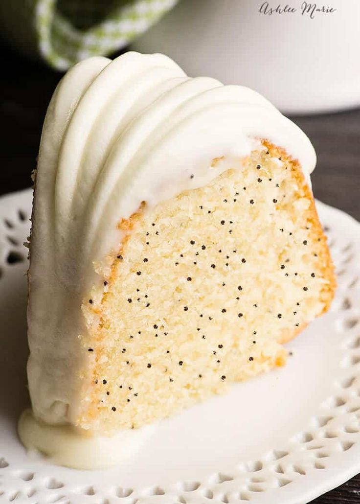 a slice of cake with white frosting on a plate