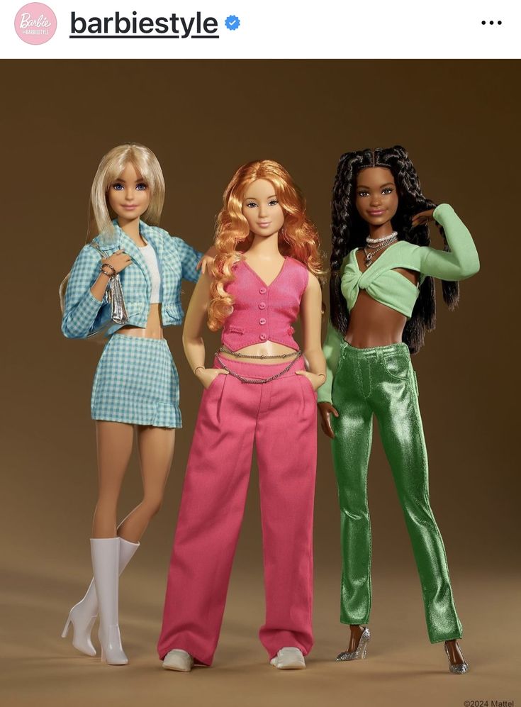 three barbie dolls standing next to each other