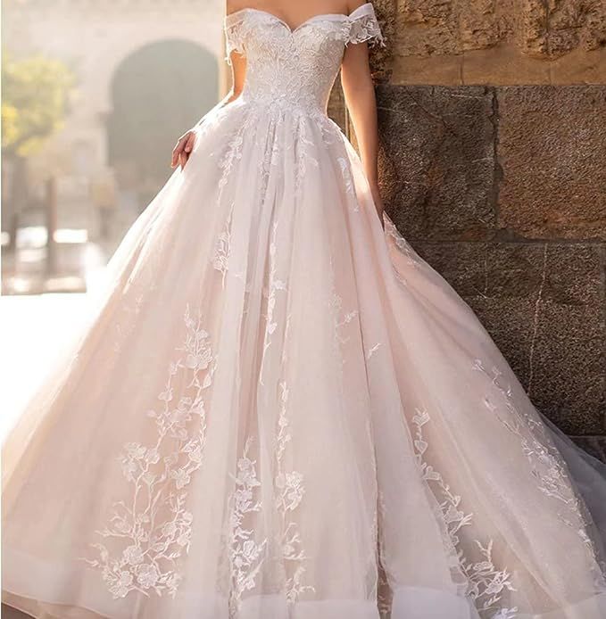 a woman in a wedding dress leaning against a wall