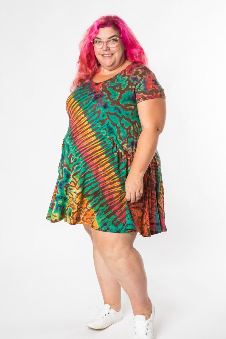 Our best-selling Althea Mudmee Tie Dye Dress in a summer-friendly short-sleeve version! This stretchy tie dye tunic dress features charming pockets and is the ultimate instant easy outfit—accessorize with some sparkling gemstone jewelry and a few boho bangles and you are ready to shine! Look no further for your new favorite colorful cozy dress with a heavy pinch of hippie-fication! Casual Tie-dye Mini Dress, Casual Multicolor Mini Dress With Short Sleeves, Casual Tie Dye Mini Dress, Casual Green Short Sleeve Dress For Summer, Casual Flowy Tie-dye Dress, Casual Flowy Tie Dye Dress, Multicolor Flowy Mini Dress With Short Sleeves, Flowy Multicolor Mini Dress With Short Sleeves, Tie Dye Short Sleeve Dress