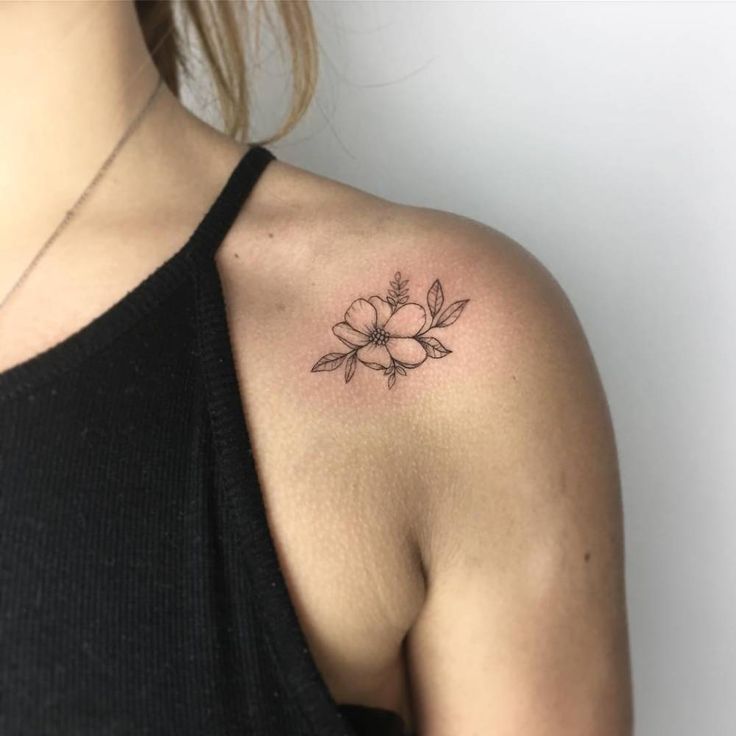 a woman with a flower tattoo on her shoulder