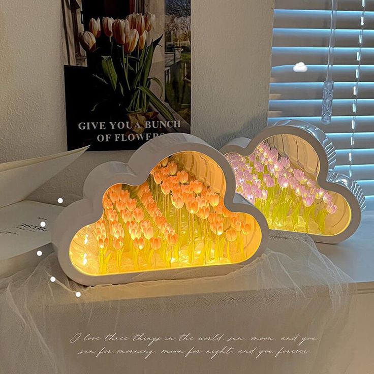 two cloud shaped lights sitting on top of a table