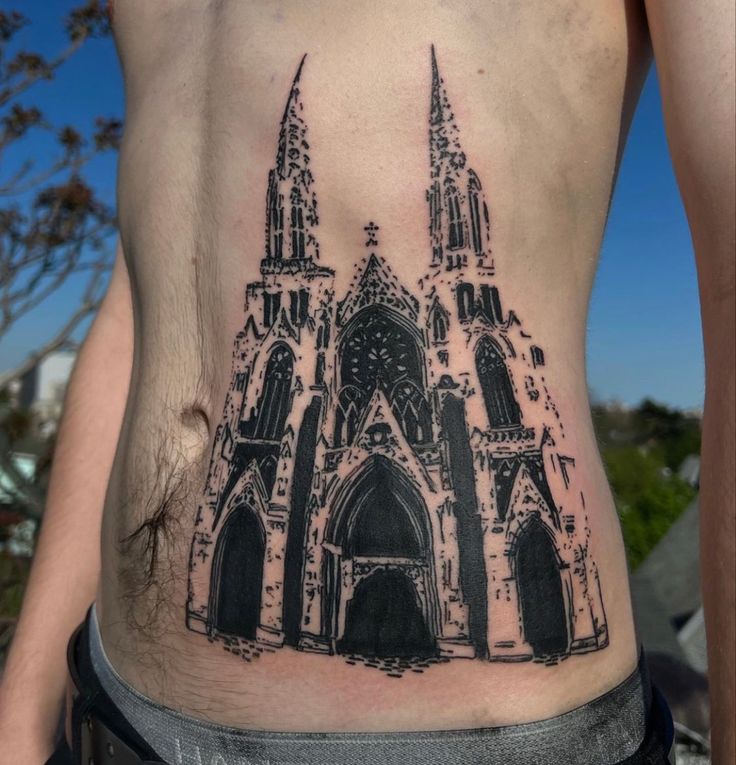 a man with a tattoo on his stomach has a large cathedral in the middle of it