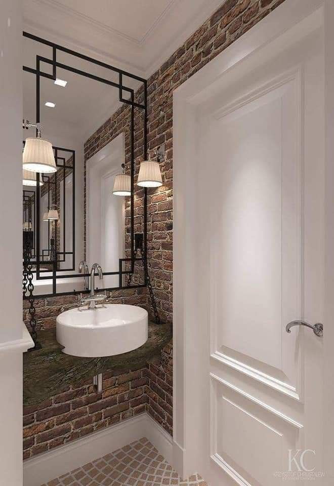 a bathroom with brick walls and a round sink in the center, surrounded by mirrors